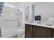 Well-lit bathroom features a shower-tub combination and a dark-stained vanity with a white countertop at 453 Treviso Dr, Poinciana, FL 34759