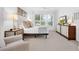 Bedroom showcasing two dressers, lots of light, and a chair with matching ottoman at 453 Treviso Dr, Poinciana, FL 34759