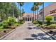 Inviting community entrance with a stone pathway, lush landscaping, and palm trees at 453 Treviso Dr, Poinciana, FL 34759