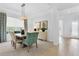 Elegant dining room featuring stylish furniture, a modern light fixture, and abundant natural light at 453 Treviso Dr, Poinciana, FL 34759