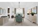Dining room with white walls, neutral carpet, a table with chairs, and elegant decor at 453 Treviso Dr, Poinciana, FL 34759