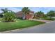 Beautifully landscaped home with a well-manicured lawn, paver driveway, and mature trees at 453 Treviso Dr, Poinciana, FL 34759