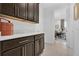 Hallway featuring built in cabinets with quartz countertop leading to an office space at 453 Treviso Dr, Poinciana, FL 34759