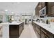 Modern kitchen with a large island, stainless steel appliances, and dark wood cabinetry at 453 Treviso Dr, Poinciana, FL 34759