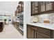 Modern kitchen with stainless steel appliances, dark wood cabinets, and plenty of counter space at 453 Treviso Dr, Poinciana, FL 34759