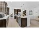 Well-equipped kitchen featuring a central island, dark cabinetry, and stainless steel appliances at 453 Treviso Dr, Poinciana, FL 34759