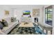 Bright living room boasts stylish decor, comfortable seating, and seamless access to outdoor views at 453 Treviso Dr, Poinciana, FL 34759