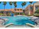 Stunning outdoor pool area featuring a Jacuzzi, lounge chairs and a lush, green garden at 453 Treviso Dr, Poinciana, FL 34759