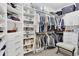 Spacious walk-in closet featuring custom shelving, hanging rods, and ample storage space at 453 Treviso Dr, Poinciana, FL 34759