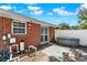 Brick house exterior showcasing a fenced-in backyard with a hot tub, perfect for relaxation at 1007 N Shore Dr, Leesburg, FL 34748