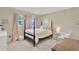 Charming bedroom with soft pink accents, a four-poster bed, and a cozy hanging chair at 1007 N Shore Dr, Leesburg, FL 34748