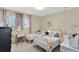 Charming bedroom featuring two beds, a study desk, and soft natural light at 1007 N Shore Dr, Leesburg, FL 34748