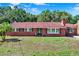 Charming brick home featuring a classic design and lush landscaping at 1007 N Shore Dr, Leesburg, FL 34748
