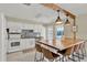 Bright kitchen featuring white cabinets, a tile backsplash, and a breakfast bar with seating for four at 1007 N Shore Dr, Leesburg, FL 34748