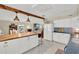 Bright kitchen boasts white cabinets, a butcher block island, and an open concept to the dining and living areas at 1007 N Shore Dr, Leesburg, FL 34748