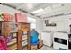 Functional laundry room with washer, dryer, and rustic wooden storage unit at 1007 N Shore Dr, Leesburg, FL 34748