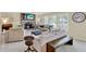 Comfortable living area featuring neutral tones, tile flooring, and a brick fireplace at 1007 N Shore Dr, Leesburg, FL 34748