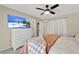 Comfortable main bedroom featuring a TV, dresser, and a doorway to the main bathroom at 1007 N Shore Dr, Leesburg, FL 34748