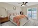 Comfortable main bedroom featuring a large bed, side tables, and windows providing natural light at 1007 N Shore Dr, Leesburg, FL 34748
