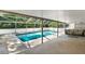 Inviting pool enclosed in a screened lanai with an outdoor lounge area at 1007 N Shore Dr, Leesburg, FL 34748