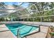 Sparkling pool enclosed in a screened lanai with lush greenery surrounding at 1007 N Shore Dr, Leesburg, FL 34748