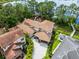 Gorgeous aerial view showcases the home's tile roof, landscaping and private dock on the lake at 10122 Royal Island Ct, Orlando, FL 32836