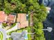 Aerial view showcasing waterfront property with private dock, pool, and lush backyard landscaping at 10122 Royal Island Ct, Orlando, FL 32836