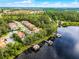 Community aerial showcasing waterfront homes with private boat docks and lush green surroundings by a lake at 10122 Royal Island Ct, Orlando, FL 32836