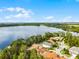 Residential area with a large lake, showing a community with lush landscaping and tile-roofed homes at 10122 Royal Island Ct, Orlando, FL 32836
