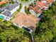 Stunning aerial view of a luxury home featuring a private pool, lush landscaping, and a clay tile roof at 10122 Royal Island Ct, Orlando, FL 32836