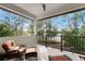 Relaxing balcony with cushioned chairs and a tranquil view of the lush surrounding landscape and serene lake at 10122 Royal Island Ct, Orlando, FL 32836