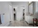 Bathroom with a double-door closet, vanity with sink, and a mirror reflecting natural light at 10122 Royal Island Ct, Orlando, FL 32836