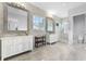 Spacious bathroom featuring double vanities, large mirrors, a walk-in shower, and neutral tile flooring at 10122 Royal Island Ct, Orlando, FL 32836
