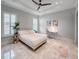 Bright bedroom with shutters, ceiling fan, desk, and carpeted floors at 10122 Royal Island Ct, Orlando, FL 32836