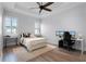 Well-lit bedroom with a ceiling fan, plantation shutters, and a dedicated computer setup for work or play at 10122 Royal Island Ct, Orlando, FL 32836
