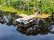Aerial view of large boat dock with lifts on a serene lake at 10122 Royal Island Ct, Orlando, FL 32836