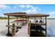 This covered boat dock with lifts and lounge chairs offers easy access to the lake at 10122 Royal Island Ct, Orlando, FL 32836