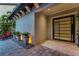 Exterior entrance featuring black framed glass door, and modern potted plants at 10122 Royal Island Ct, Orlando, FL 32836