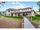 Expansive waterfront property featuring lush landscaping, a private dock, and elegant outdoor living spaces at 10122 Royal Island Ct, Orlando, FL 32836