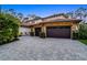Stately home featuring stone accents, a tile roof, and a spacious driveway with a three-car garage at 10122 Royal Island Ct, Orlando, FL 32836