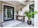 Stylish home foyer with patterned stone floors, a console table, and a modern glass door at 10122 Royal Island Ct, Orlando, FL 32836