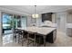 Spacious kitchen with an oversized island, marble countertops, and sleek, dark cabinetry at 10122 Royal Island Ct, Orlando, FL 32836