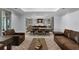 Inviting living room featuring a unique coffee table and seamless flow into the adjacent dining and kitchen areas at 10122 Royal Island Ct, Orlando, FL 32836
