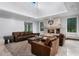 Comfortable living room with leather seating and a stone fireplace, perfect for relaxing and entertaining guests at 10122 Royal Island Ct, Orlando, FL 32836