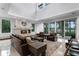 Open living room with a stone fireplace, high ceilings, and sliding doors offering lake views at 10122 Royal Island Ct, Orlando, FL 32836