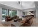Expansive living room with a wall of sliding glass doors, offering stunning water views and natural light at 10122 Royal Island Ct, Orlando, FL 32836