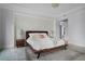 Bright bedroom featuring textured wall, tray ceiling, and modern decor at 10122 Royal Island Ct, Orlando, FL 32836