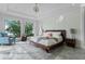 Bright main bedroom featuring textured wall, large windows and modern decor at 10122 Royal Island Ct, Orlando, FL 32836