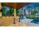 Outdoor kitchen featuring a BBQ, bar seating and views of the luxury lounge and waterfront deck at 10122 Royal Island Ct, Orlando, FL 32836