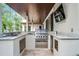 Well-equipped outdoor kitchen with granite countertops, stainless steel grill, and custom cabinetry, perfect for al fresco dining and entertaining at 10122 Royal Island Ct, Orlando, FL 32836